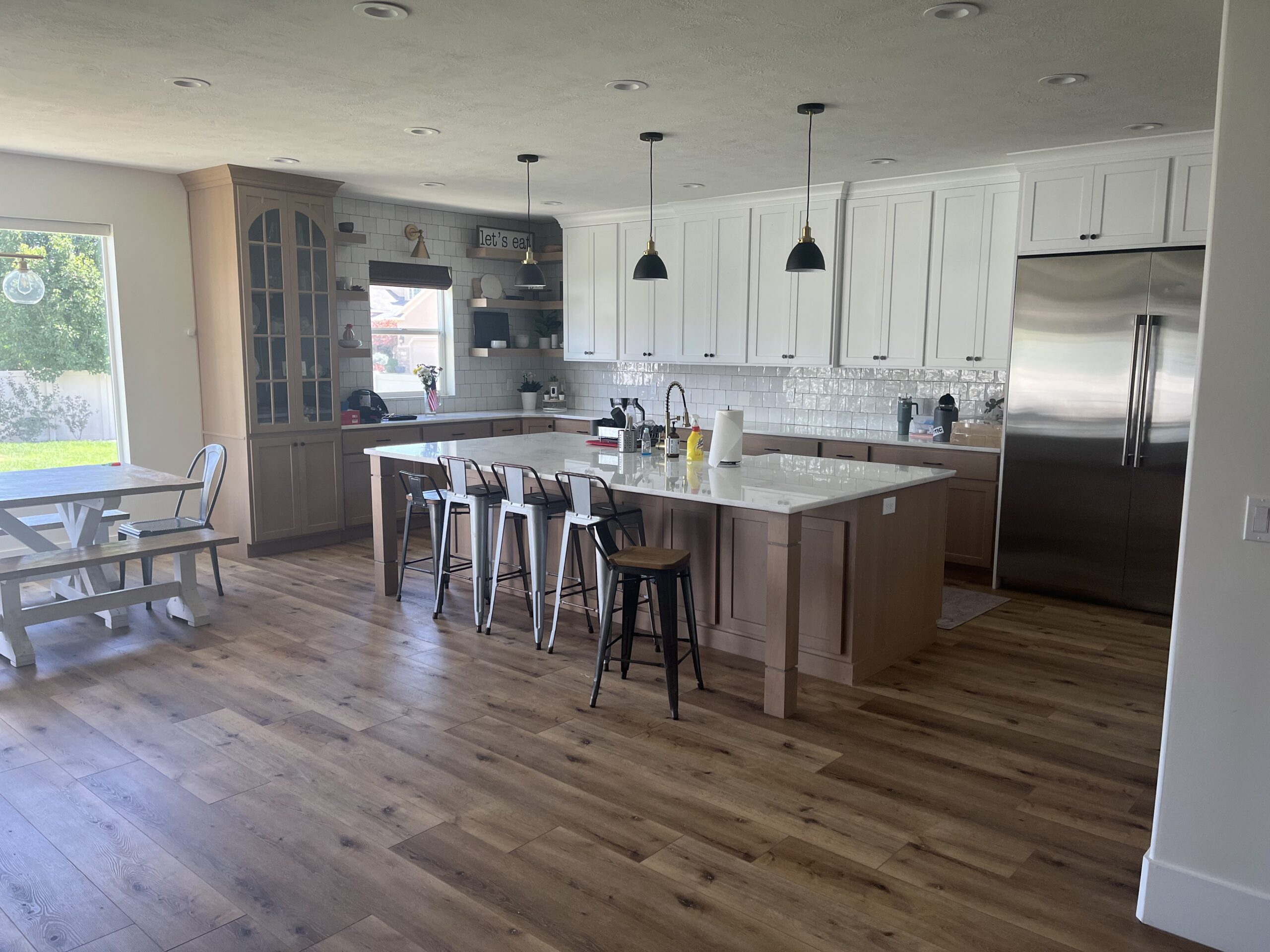 Warm, modern luxury kitchen with premium materials, spacious layout, and natural light designed by Roots Builders.