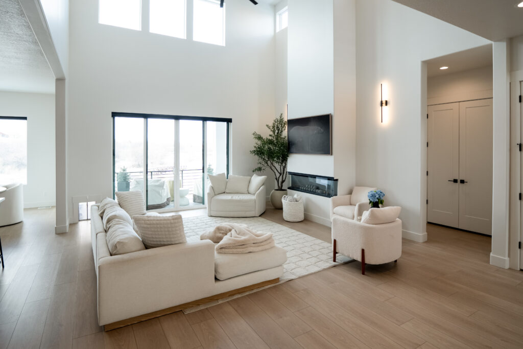 Modern custom living room with clean lines, natural light, and open layout by Roots Builders