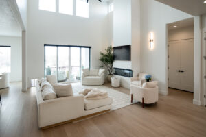Modern custom living room with clean lines, natural light, and open layout by Roots Builders