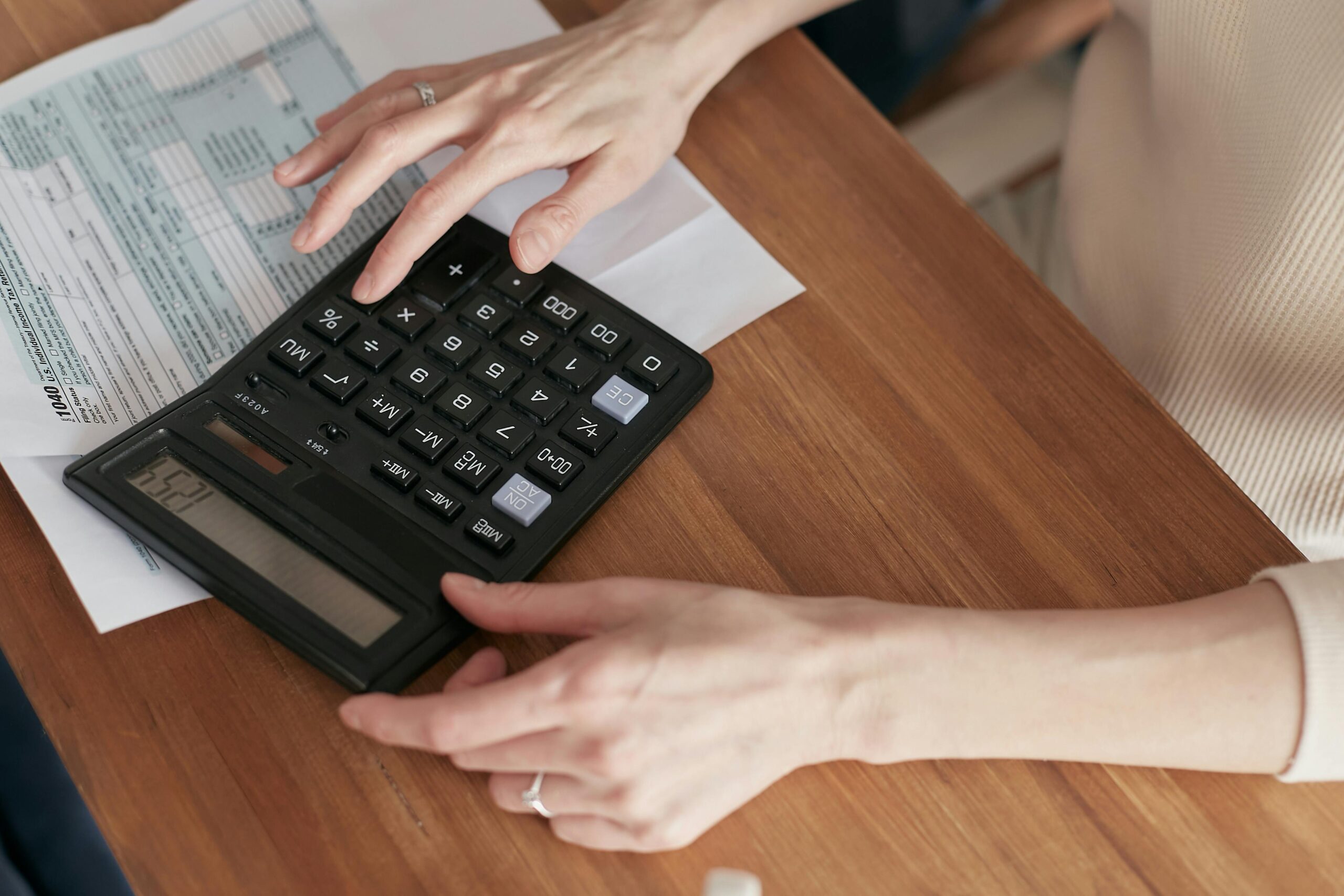 Person on table calculating the cost of a custom home in Utah