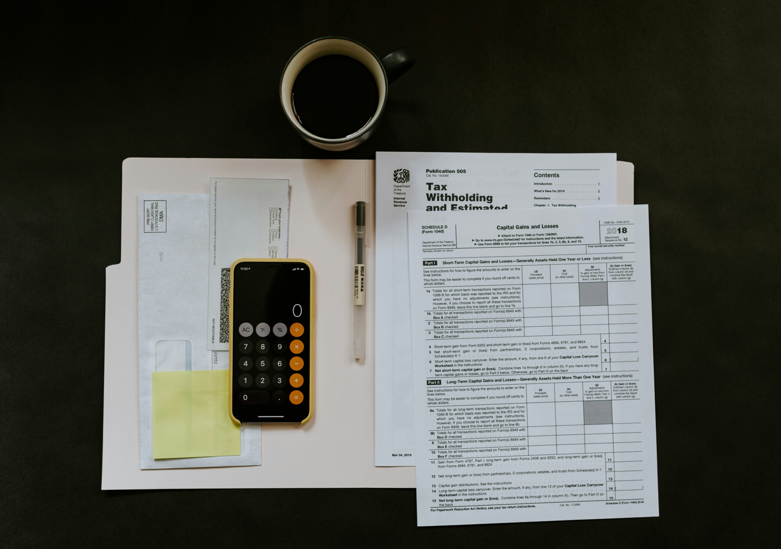 Flat lay of tax forms, calculator, pen, and coffee cup symbolizing homeowner tax deductions and planning.