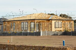 A new custom home in Utah under construction with exposed wooden framing and scaffolding
