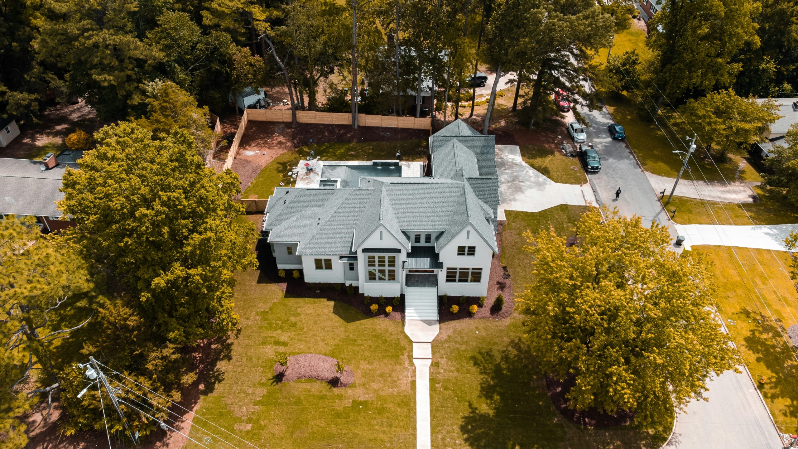 Aerial view of custom home built by Utah home builders featuring quality craftsmanship and mature landscaping