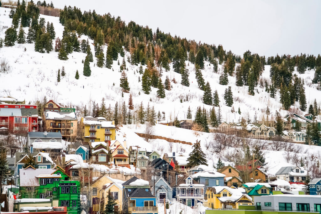 Houses and cabins on a mountain blanketed with snow in Park City Utah in winter.